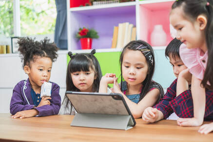 Group of children looking at tablet