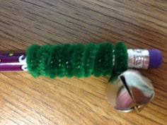 fancy pencil with bell and pipe cleaner wrapped around end