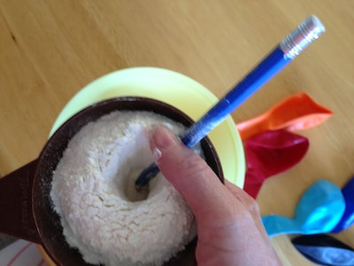 pencil pushing flour through the funnel