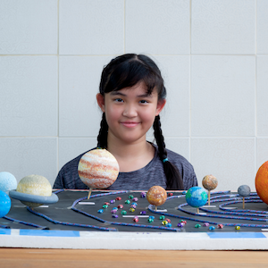 girl with model of the solar system